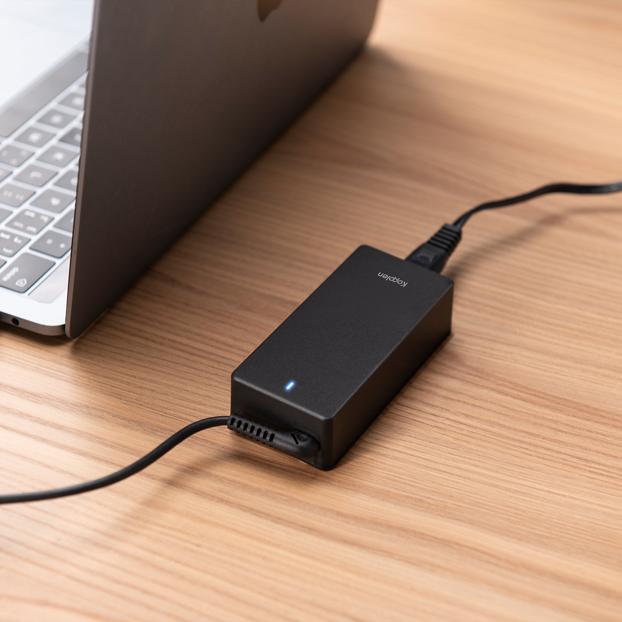 Close up of blue led from the Power adapter plugged into macbook via USB-C cable