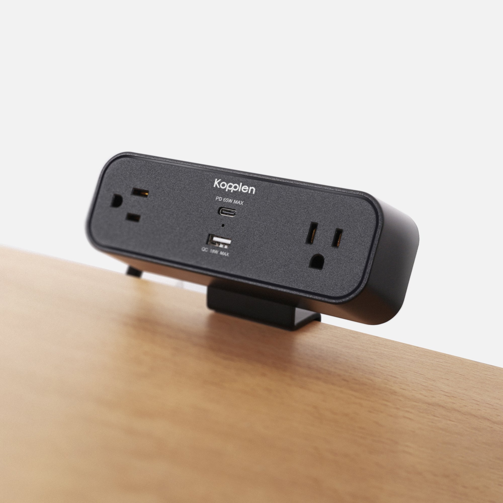 Power strip clamped to wooden table