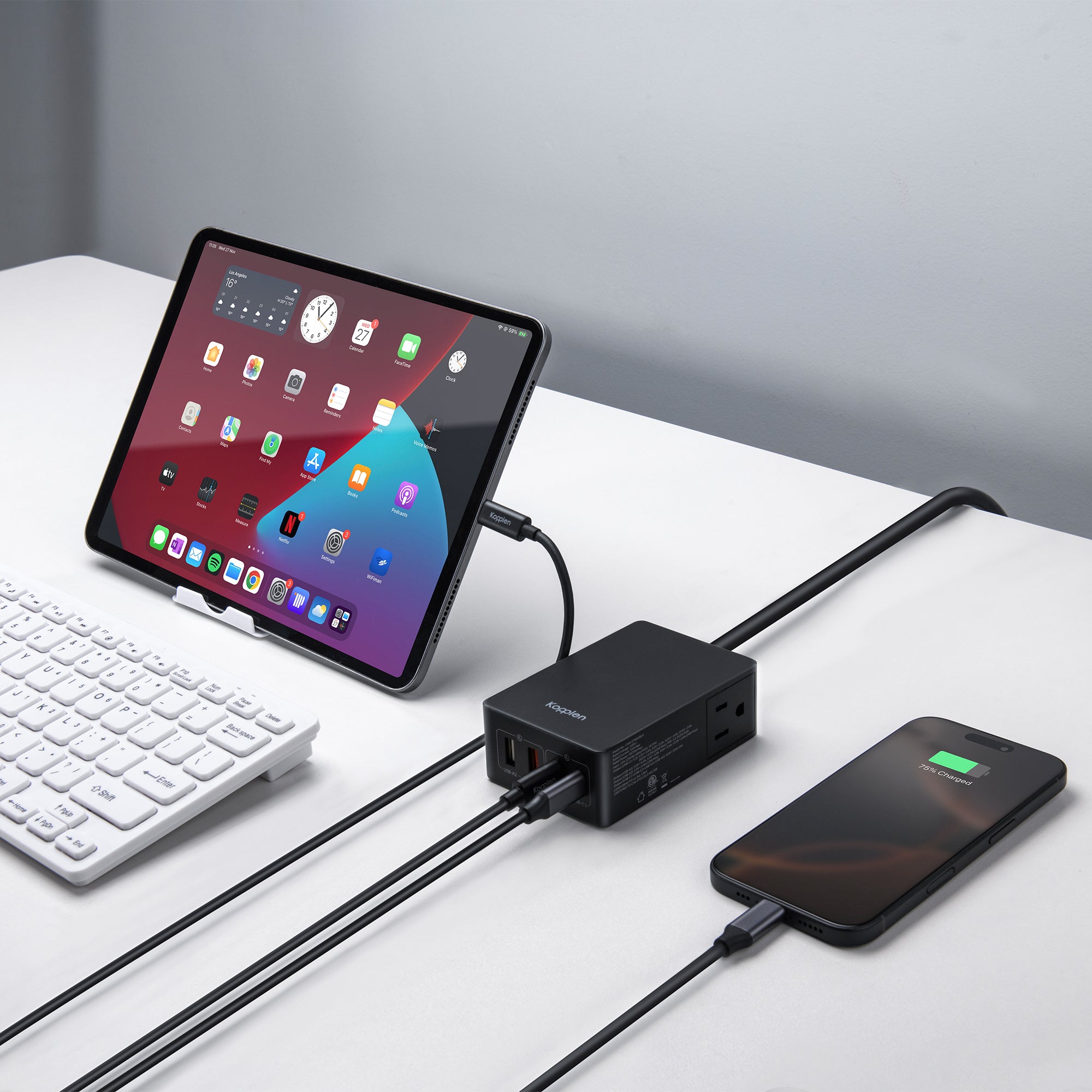 Power adapter with an iPad and iPhone plugged into it, charging