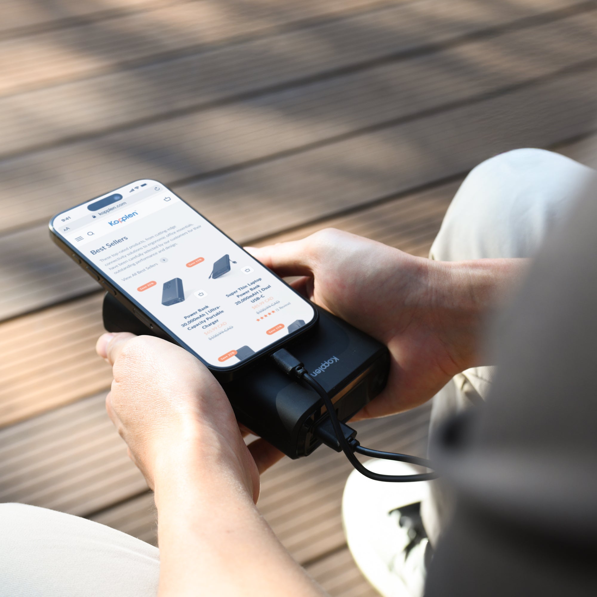 iphone being charged by power bank held in hands