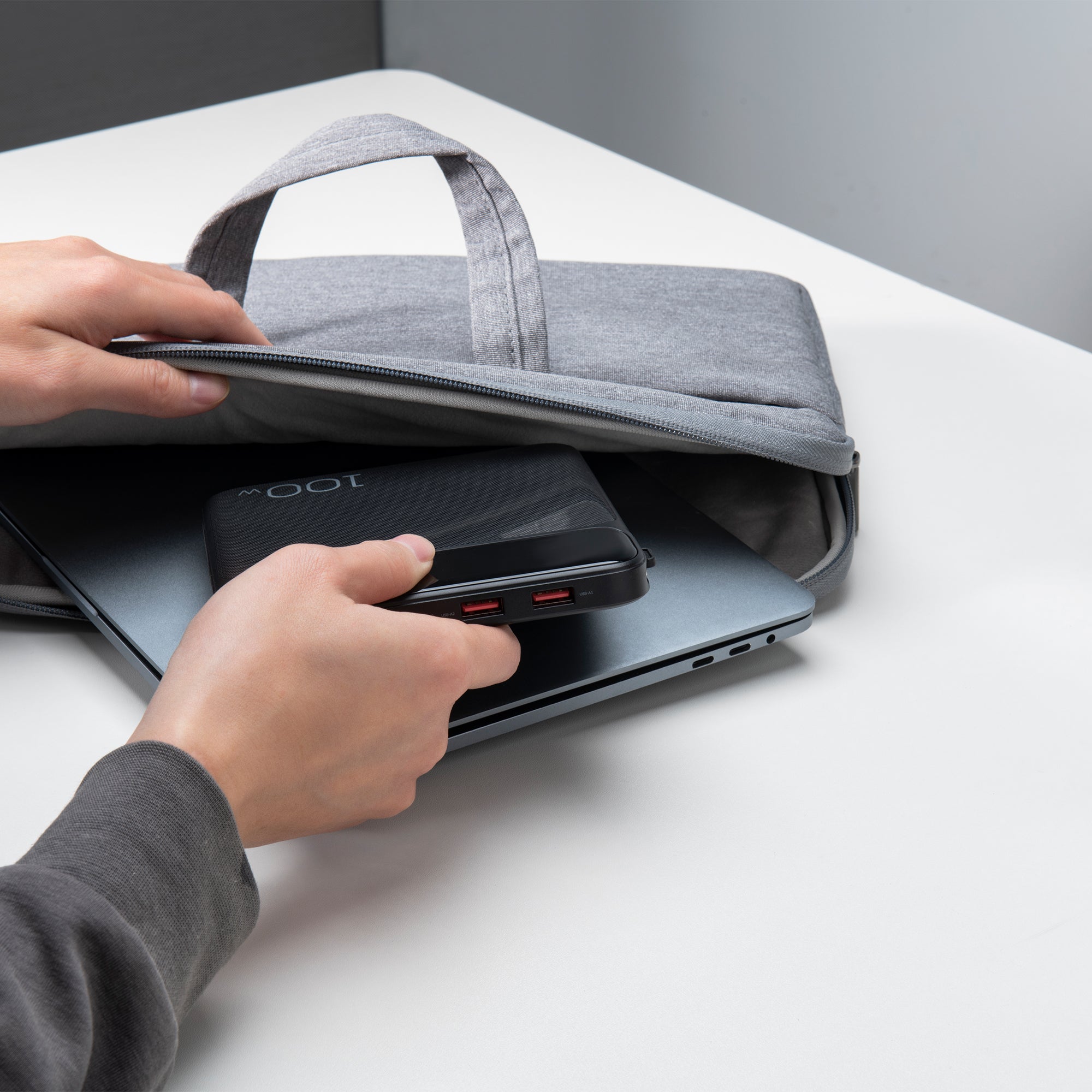 Slim power bank being placed into a laptop bag