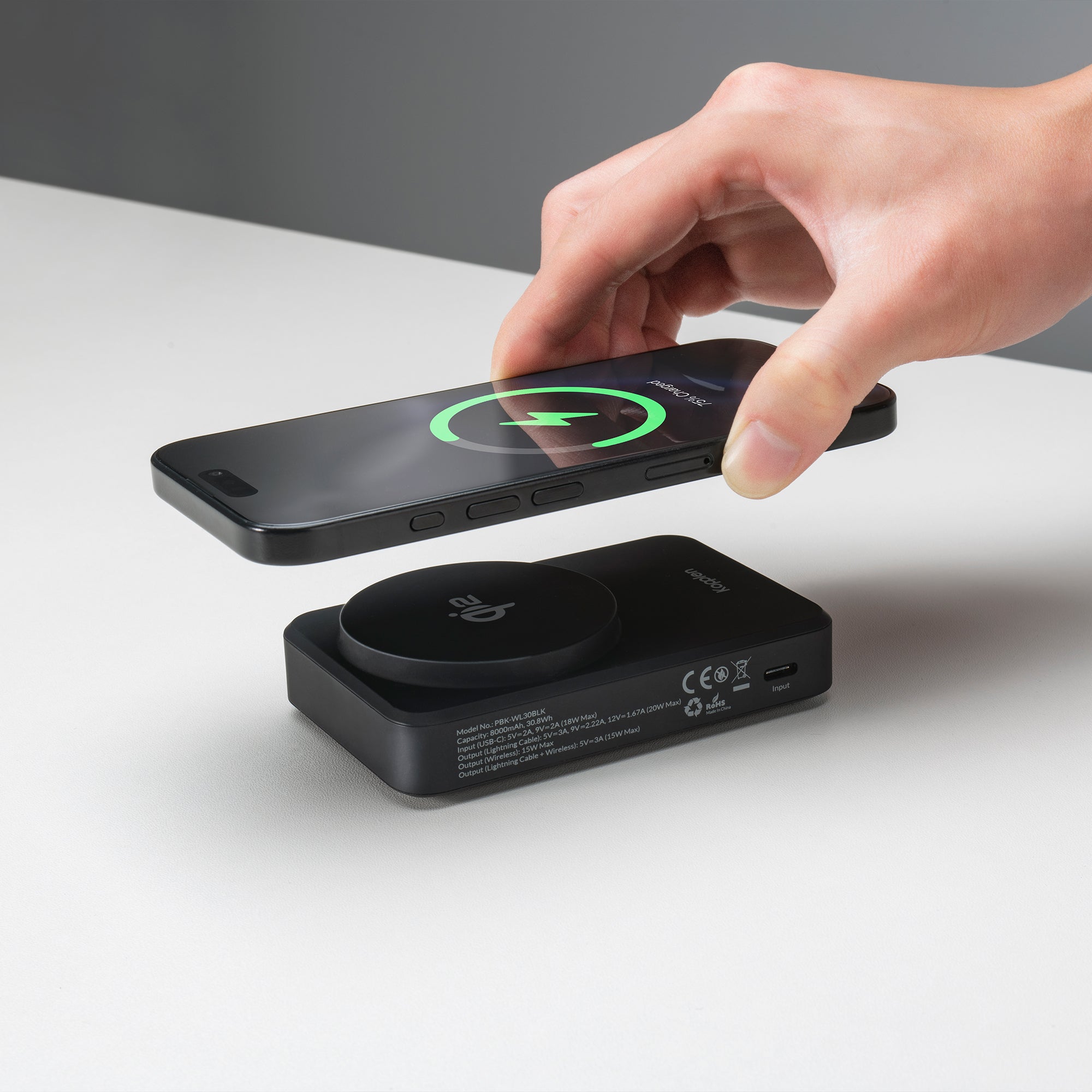 Phone being placed on to wireless phone power bank charger