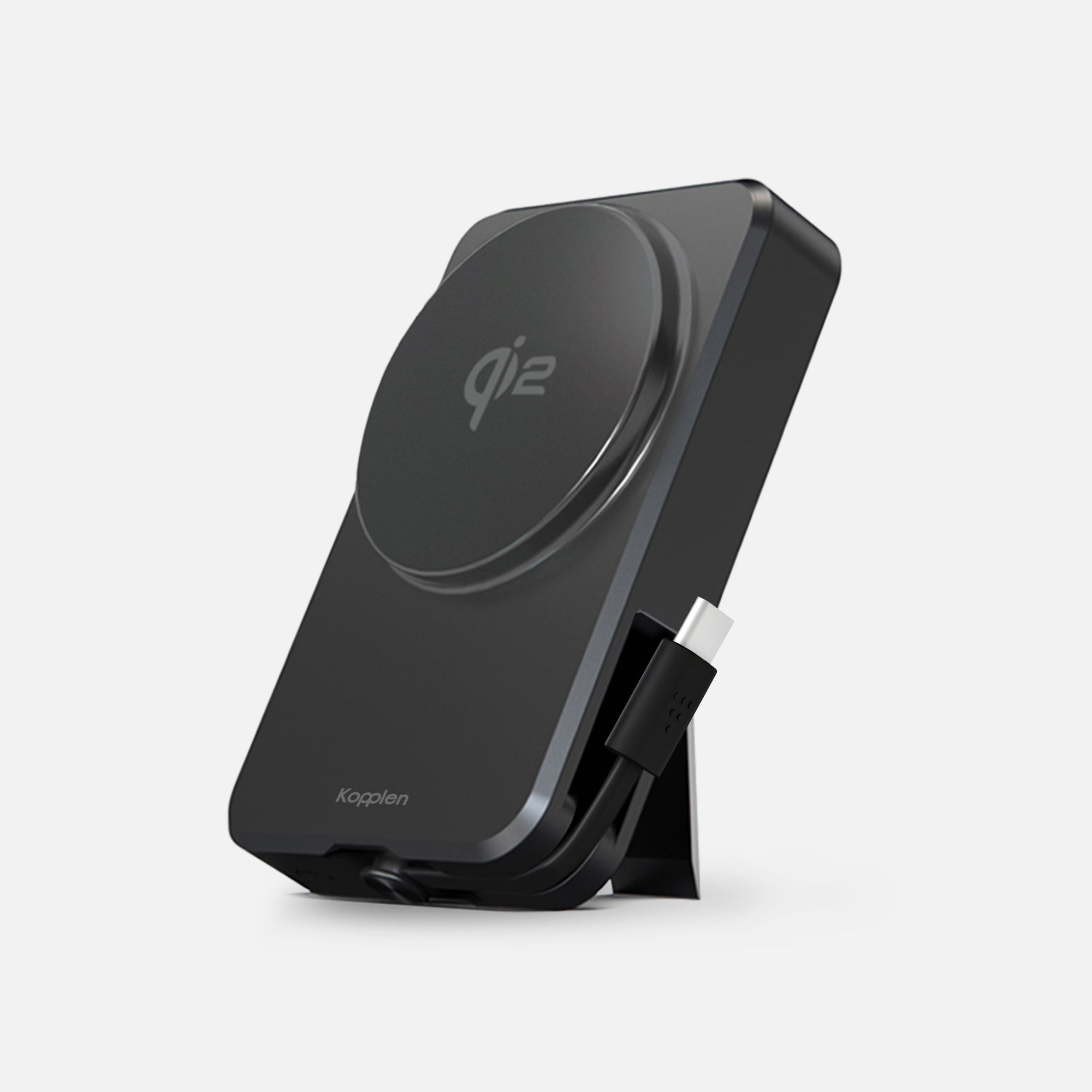 Power bank leaning on built-in stand with USB-C cable loose