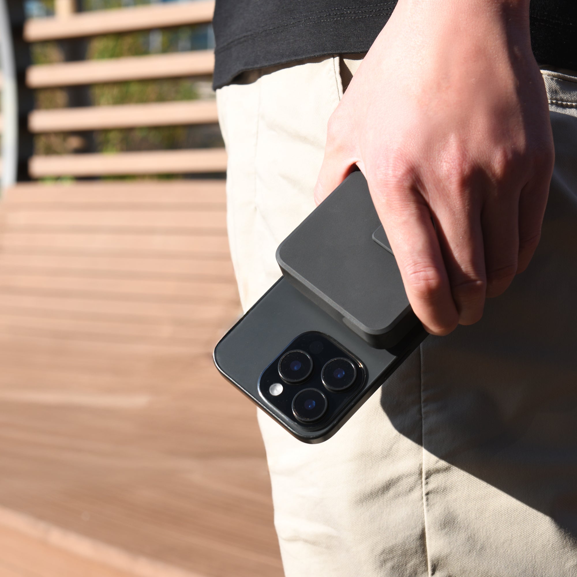 Power Bank attached to iPhone held in hand